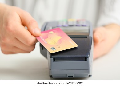 Woman Using Bank Terminal For Credit Card Payment, Closeup