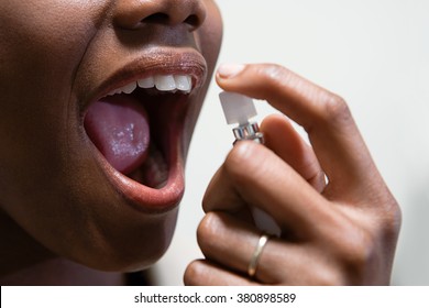 Woman Using Breath Freshener