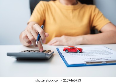 Woman using calculator during signing contract document. buy and sale, insurance, rental and contract agreement concepts - Shutterstock ID 2137466753