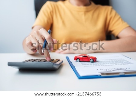 Woman using calculator during signing contract document. buy and sale, insurance, rental and contract agreement concepts