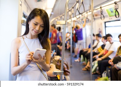 Woman using cellphone inside train compartment - Powered by Shutterstock