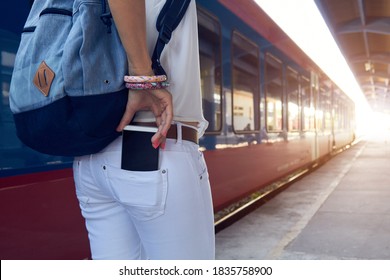 Woman using cellphone on a train station.