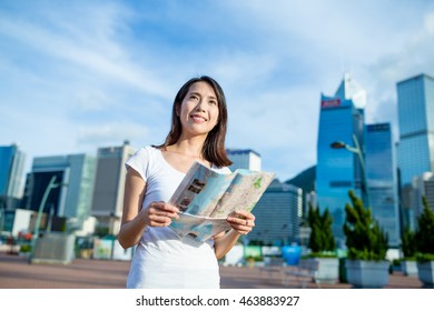 Woman Using City Guide In Hong Kong