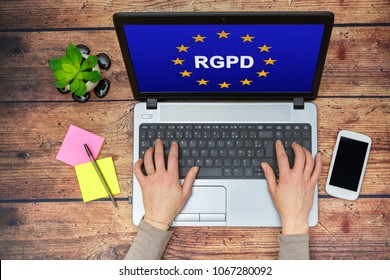 Woman Using A Computer With Flag Of European Union With RGPD Word Inside On The Screen