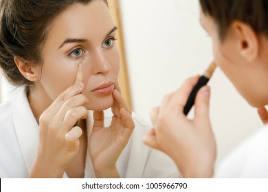 Woman Using Concealer For Under Eye Circles