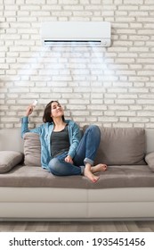 Woman Using Conditioner In Room. Living Room Cooling