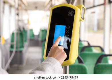 Woman using contactless fare payment device in public transport, closeup