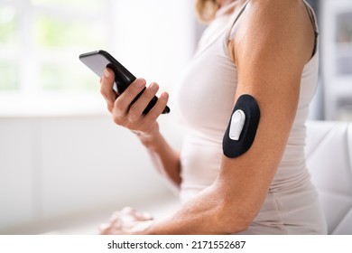 Woman Using Continuous Glucose Remote Monitor Diabetes Sensor