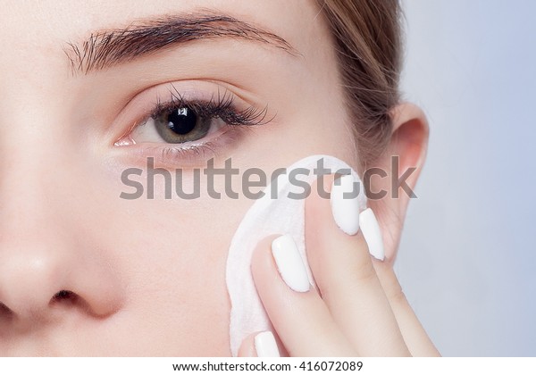 Woman\
using cotton pad. Happy smiling beautiful young woman cleaning skin\
by cotton pad. light background. Beautiful Spa Woman Smiling.\
Perfect Fresh Skin. Youth and Skin Care\
Concept
