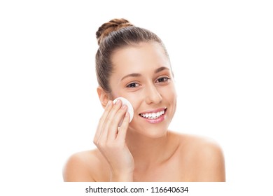 Woman Using Cotton Pad On Face