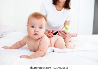 Woman Using Cream Before  Wearing A Diaper For A Baby