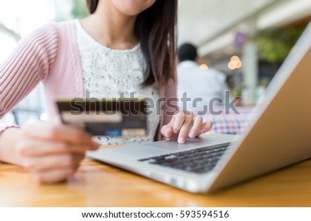 Woman using credit card to pay the bill