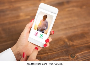 Woman using dating app and swiping user photos - Shutterstock ID 1067926880