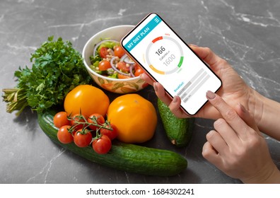 Woman Using Dieting App To Track Nutrition Facts And Calories In Her Food