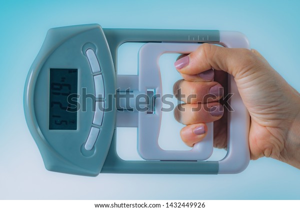 Woman Using Digital\
Hand Grip Dynamometer
