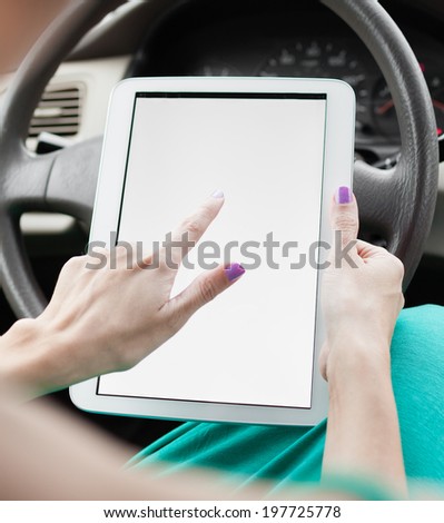 Woman using digital tablet in the car.