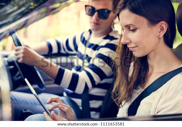 Woman using a digital\
tablet in the car