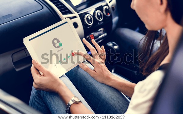 Woman using a digital\
tablet in the car