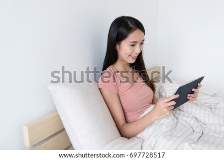Woman using digital tablet computer at home