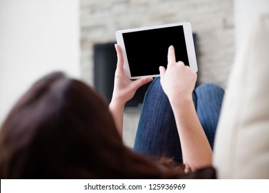 Woman Using Digital Tablet On Couch