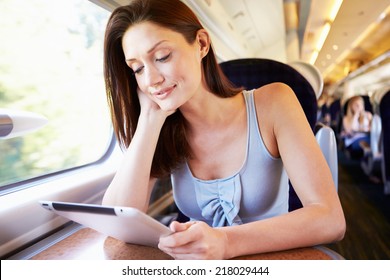 Woman Using Digital Tablet On Train