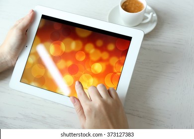 Woman Using Digital Tablet On Table Close Up