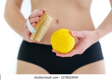 Woman Using Dry Wooden Brush For Massaging And Brushing Skin To Prevent And Treatment Cellulite And Body Problem At Home. Skin Health