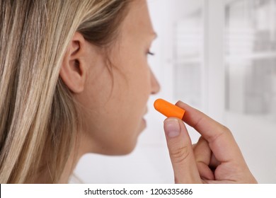 Woman Using Earplugs For Sleeping