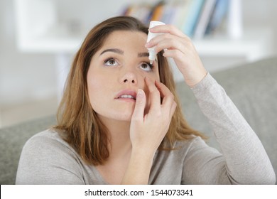 Woman Using Eye Drops In Eyes