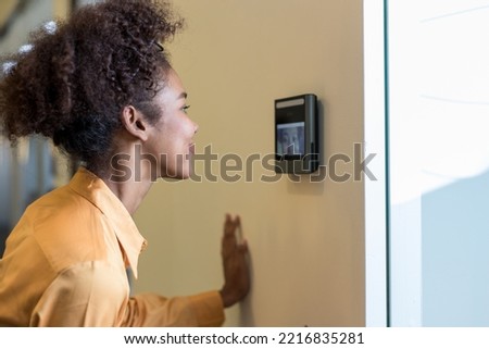 Woman using face scanner to unlock door in office building. Access control facial recognition system. Biometric admittance control device for security system. Biometric admittance control device 