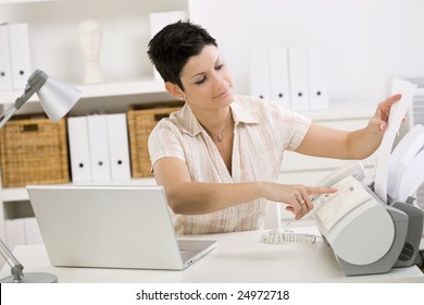 Woman Using Fax Machine At Home Office.