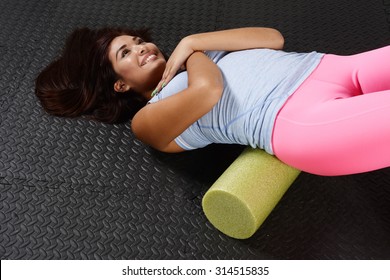 Woman Using A Foam Roller After A Workout