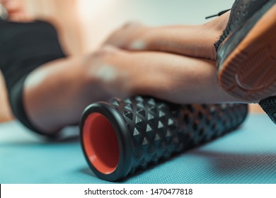 Woman Using Foam Roller for Muscle and Fascia Stretching - Powered by Shutterstock