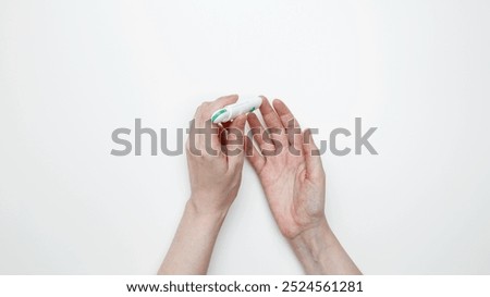 Woman using glucometer for testing level Blood sugar. Top view