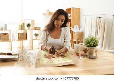 Woman Using Glue Gun When Working On New Project