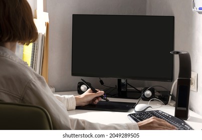 Woman Using Graphics Pad To Retouching.Computer Monitor,keyboard,drawing Tab,lamp On The White Office Desk.Empty Space