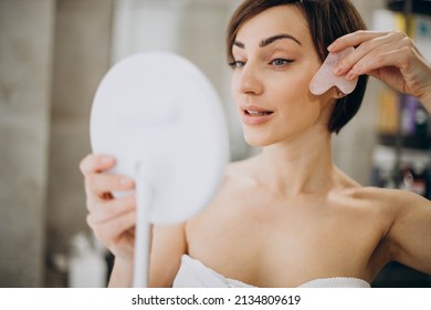 Woman Using Gua Sha Stone At Spa