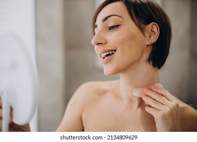 Woman Using Gua Sha Stone At Spa