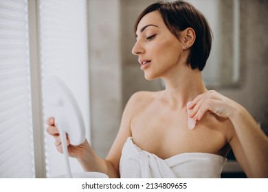 Woman Using Gua Sha Stone At Spa