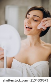 Woman Using Gua Sha Stone At Spa