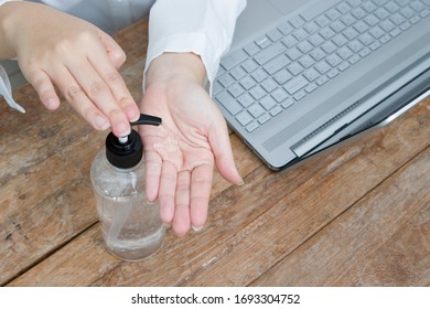 Woman Is Using Hand Sanitize Alcohol Gel To Clean Hand Before Using Computer While Working At Home. 