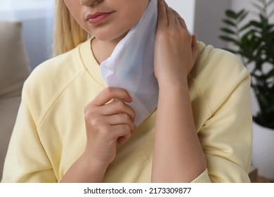 Woman Using Heating Pad At Home, Closeup