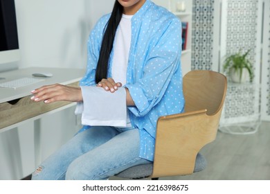 Woman Using Heating Pad At Home, Closeup