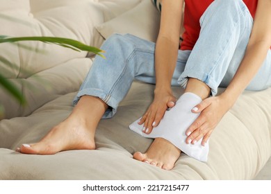 Woman Using Heating Pad At Home, Closeup