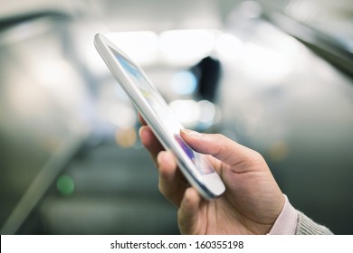 Woman using her cell phone in Subway on escalator  - Powered by Shutterstock