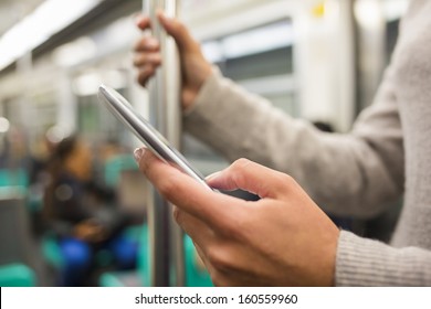 Woman Using Her Cell Phone In Subway