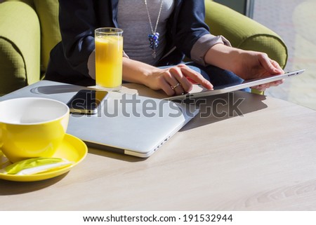 Woman using her mobile devices in cafe