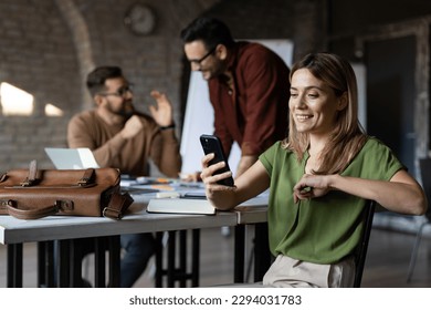 Woman using her smartphone at office