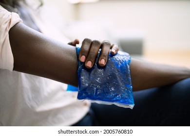 Woman Using Ice Gel Pack On Injured Arm