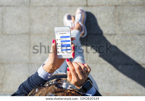 Woman using\
instant messaging app on mobile\
phone